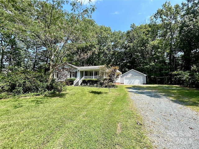 view of front of property with a front lawn, a garage, an outdoor structure, and a porch