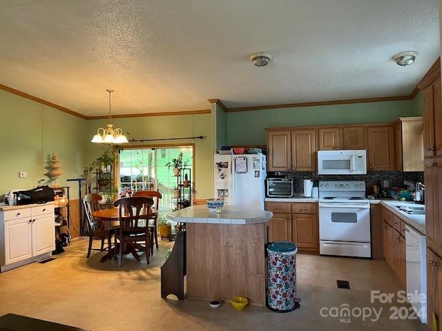 kitchen with white appliances, a textured ceiling, a notable chandelier, hanging light fixtures, and light tile patterned floors