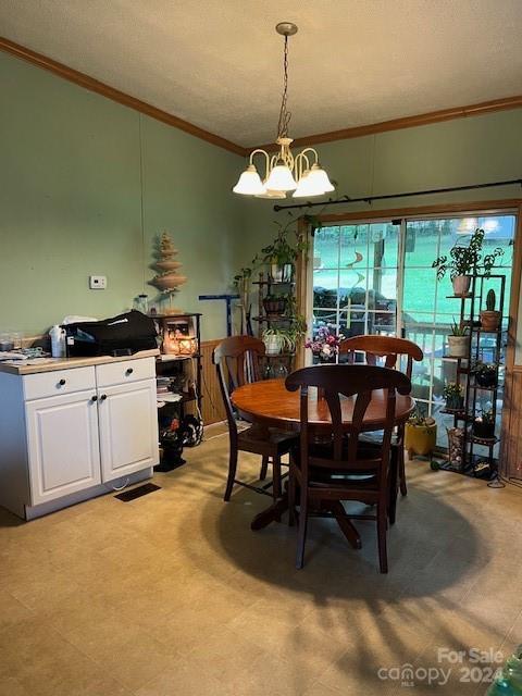 tiled dining room with crown molding and an inviting chandelier