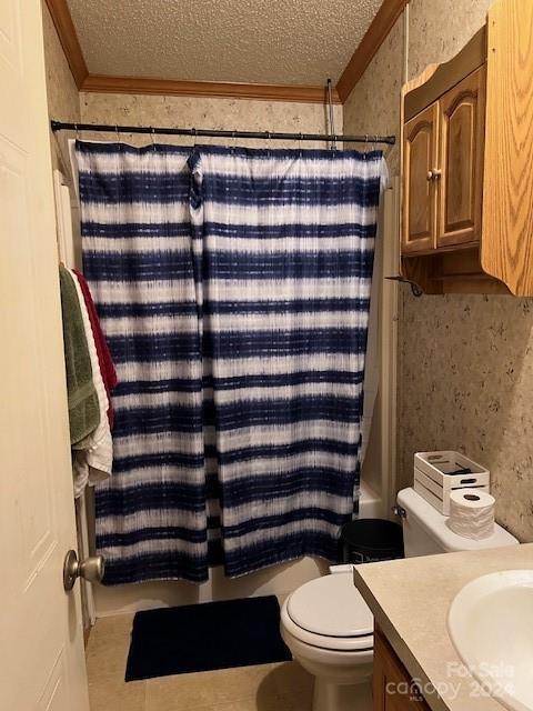 full bathroom with shower / bathtub combination with curtain, a textured ceiling, vanity, and toilet