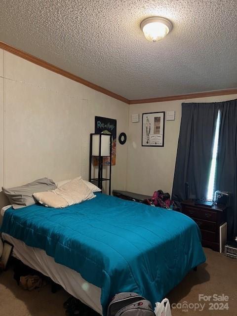 carpeted bedroom featuring a textured ceiling