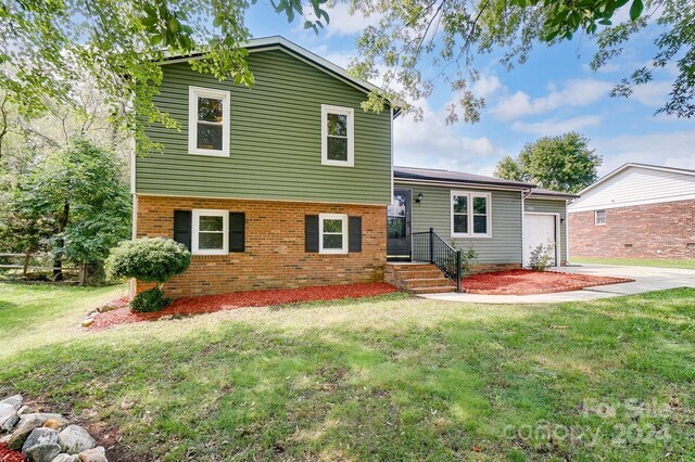 exterior space with a garage and a yard