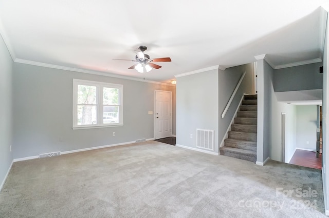 spare room featuring ceiling fan, ornamental molding, and light colored carpet