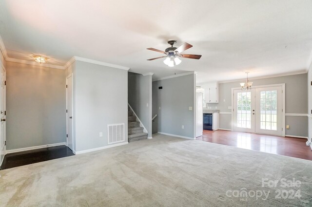 unfurnished living room with ornamental molding, carpet floors, ceiling fan with notable chandelier, and wine cooler