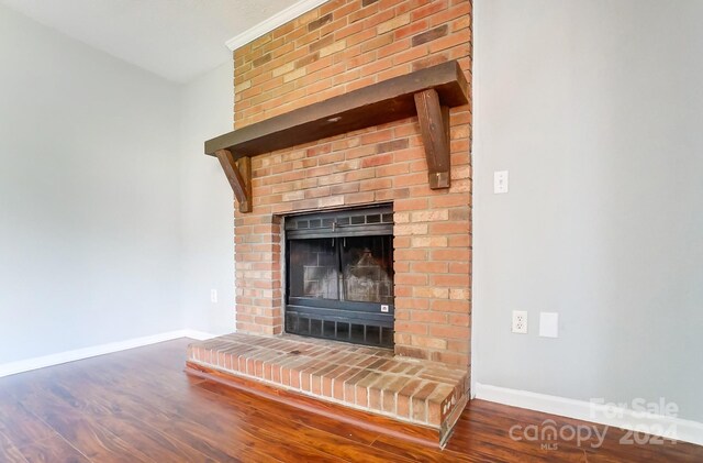 room details featuring a fireplace and hardwood / wood-style flooring