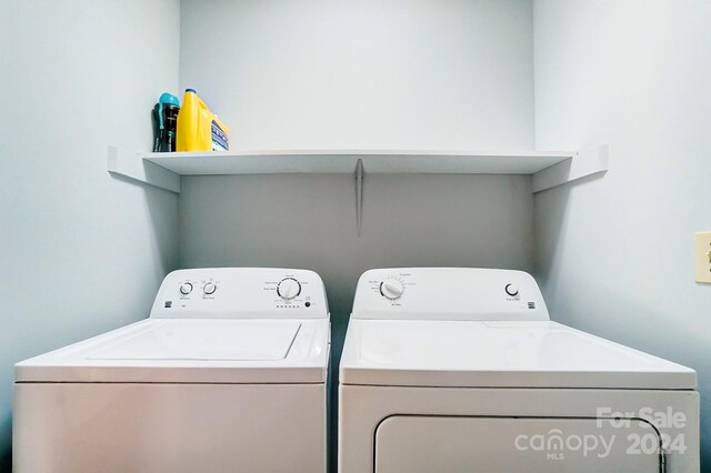 washroom with washing machine and clothes dryer