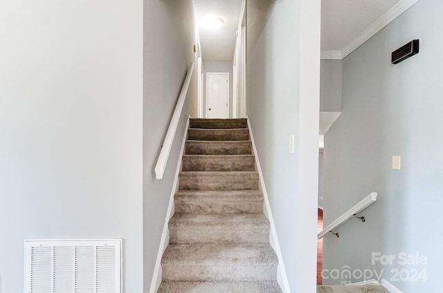 stairs with crown molding