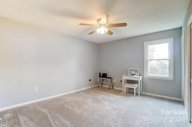 spare room with carpet flooring and ceiling fan