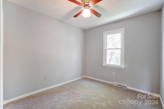 carpeted spare room with ceiling fan