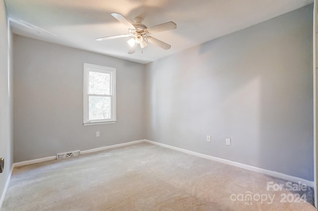 empty room featuring carpet flooring and ceiling fan