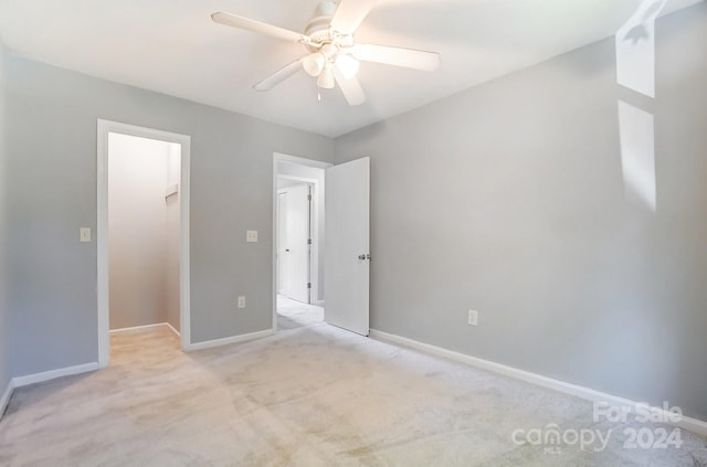 carpeted empty room featuring ceiling fan