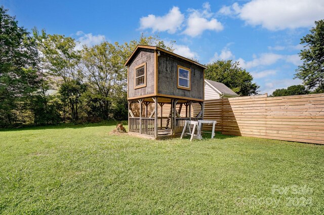 rear view of property with a yard