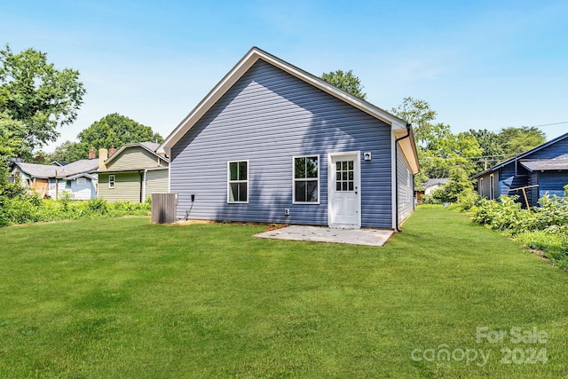 back of property featuring a patio, a yard, and central AC