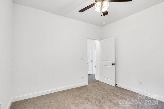 carpeted empty room with ceiling fan