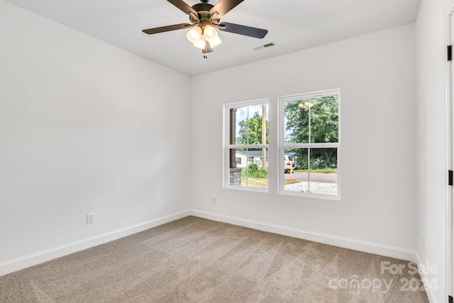 unfurnished room with carpet and ceiling fan