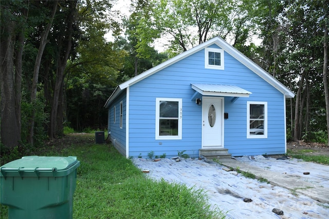 bungalow featuring central AC unit