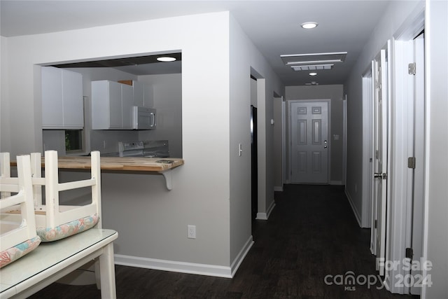 hallway with dark hardwood / wood-style flooring