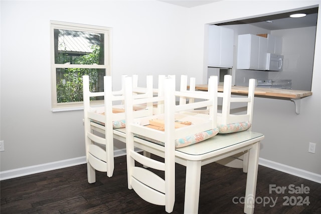 dining area with dark hardwood / wood-style floors