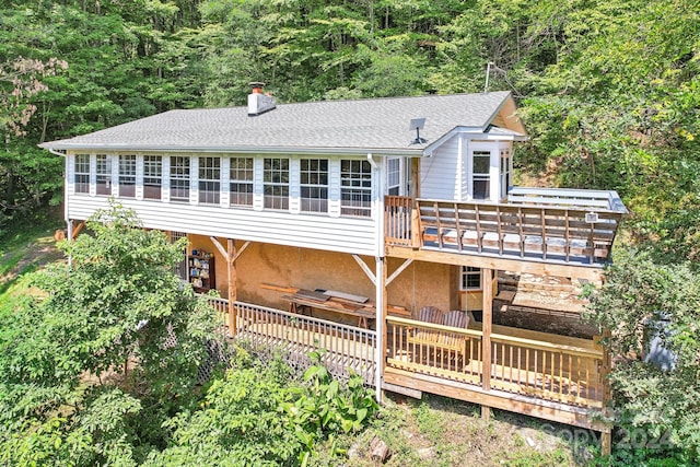 back of property featuring a wooden deck