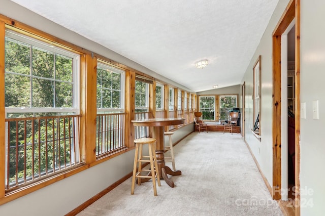 sunroom / solarium featuring vaulted ceiling