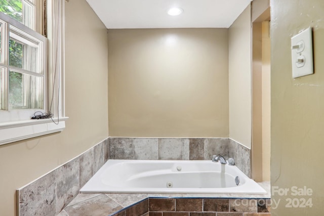 bathroom with tiled bath