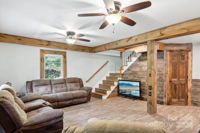 living room featuring light hardwood / wood-style flooring, ceiling fan, and a fireplace