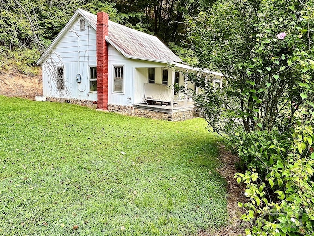 view of outbuilding featuring a lawn