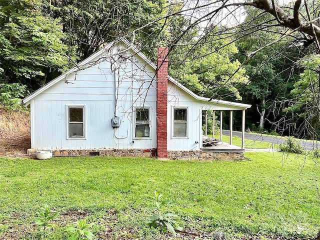 view of property exterior featuring a lawn