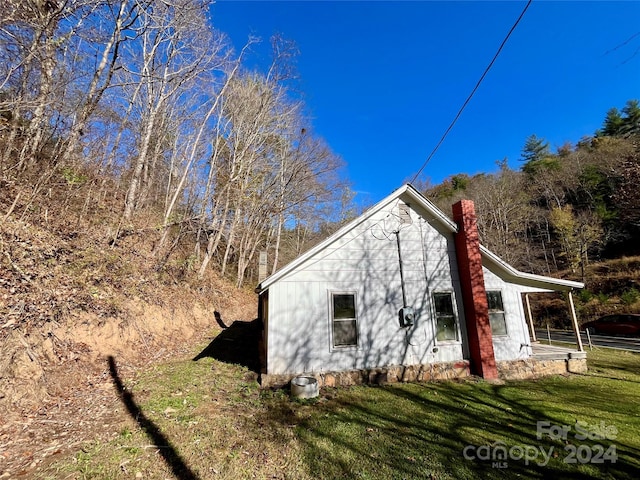 view of property exterior with a yard