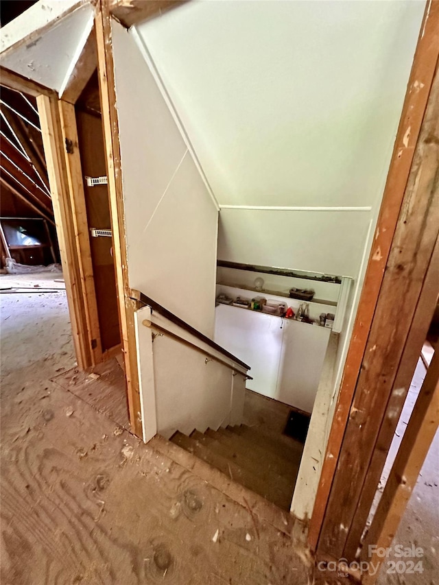 stairway featuring vaulted ceiling