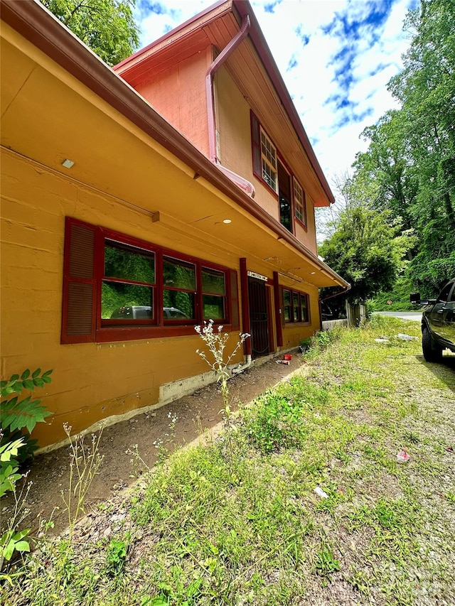 view of side of home featuring a lawn