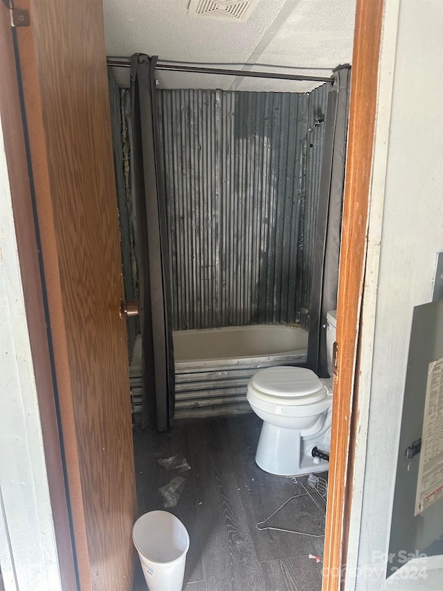 bathroom featuring washtub / shower combination and toilet