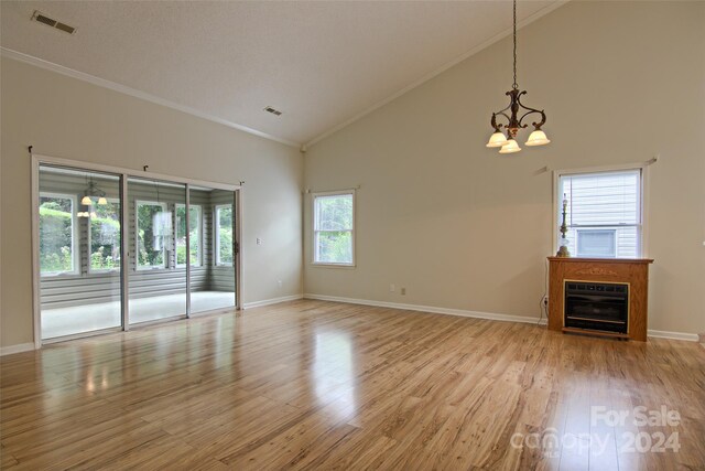 unfurnished living room featuring crown molding, high vaulted ceiling, and light hardwood / wood-style flooring