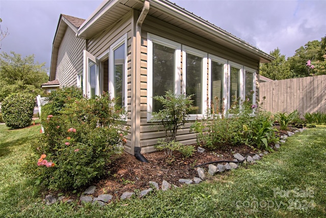 view of property exterior with a lawn