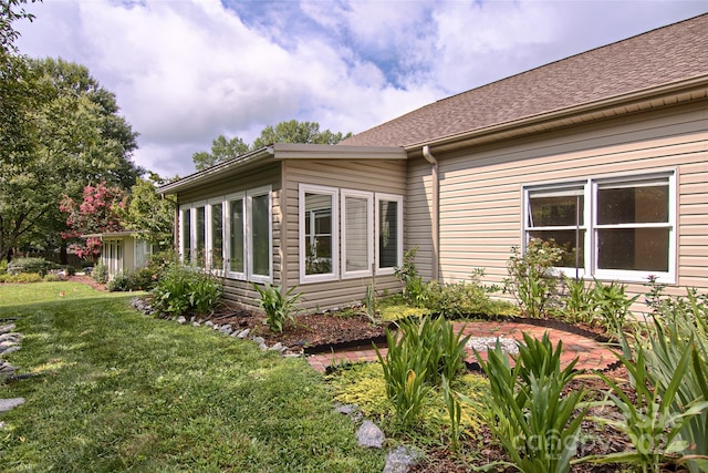 view of side of home featuring a lawn