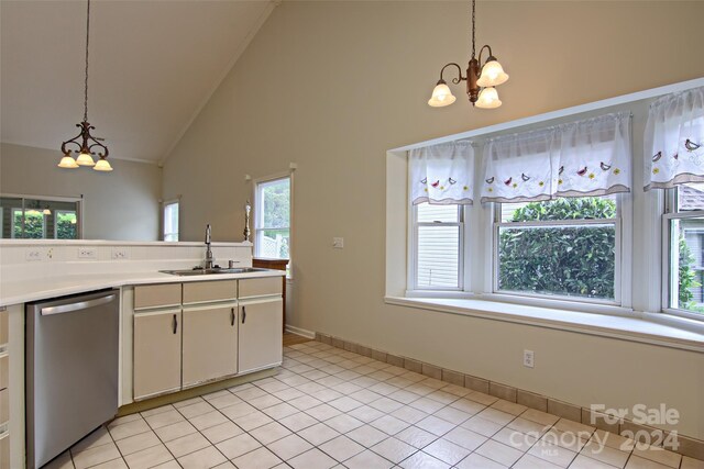 kitchen featuring light tile patterned floors, a wealth of natural light, dishwasher, and sink