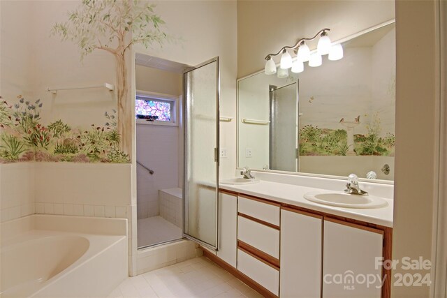 bathroom with plus walk in shower, double vanity, and tile patterned flooring