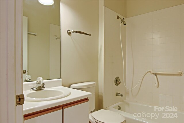 full bathroom with toilet, vanity, and tiled shower / bath