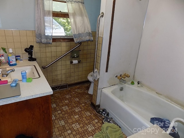 bathroom with vanity, tile patterned flooring, and toilet