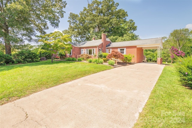 ranch-style house featuring a carport and a front yard