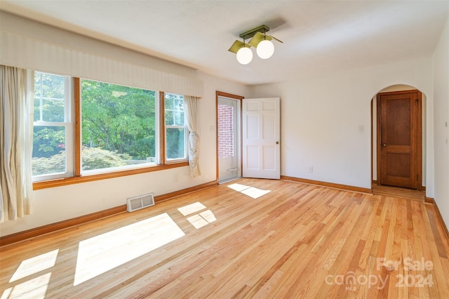 unfurnished bedroom featuring light hardwood / wood-style flooring, multiple windows, and ceiling fan