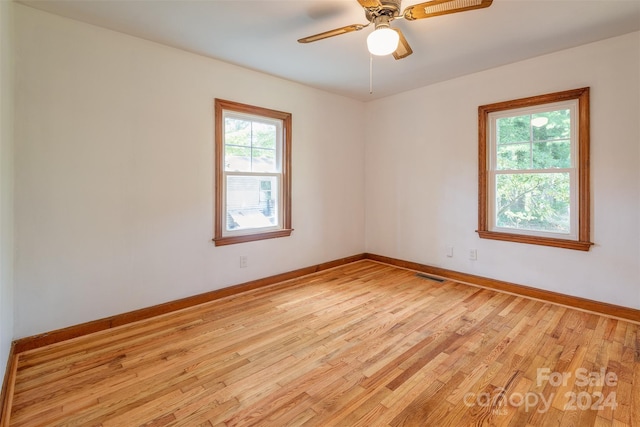 spare room featuring ceiling fan and light hardwood / wood-style floors