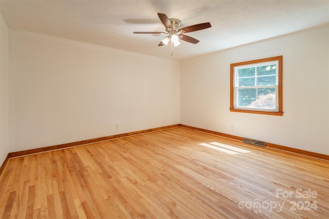 unfurnished room with ceiling fan and light wood-type flooring