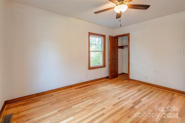 empty room with light hardwood / wood-style floors and ceiling fan