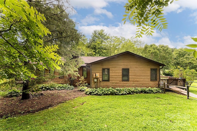 view of home's exterior with a lawn