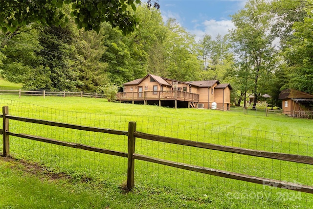 view of yard featuring a wooden deck and a rural view