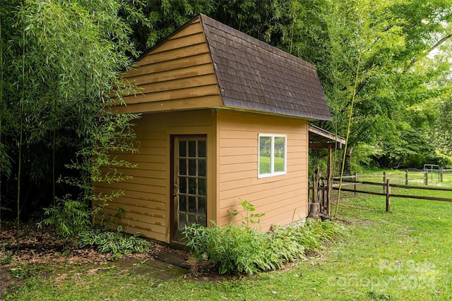 view of outbuilding featuring a lawn