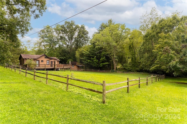 view of yard with a rural view and a deck