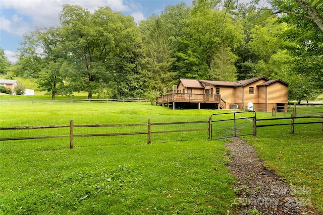 view of yard featuring a rural view and a deck