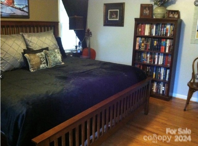 bedroom with hardwood / wood-style floors